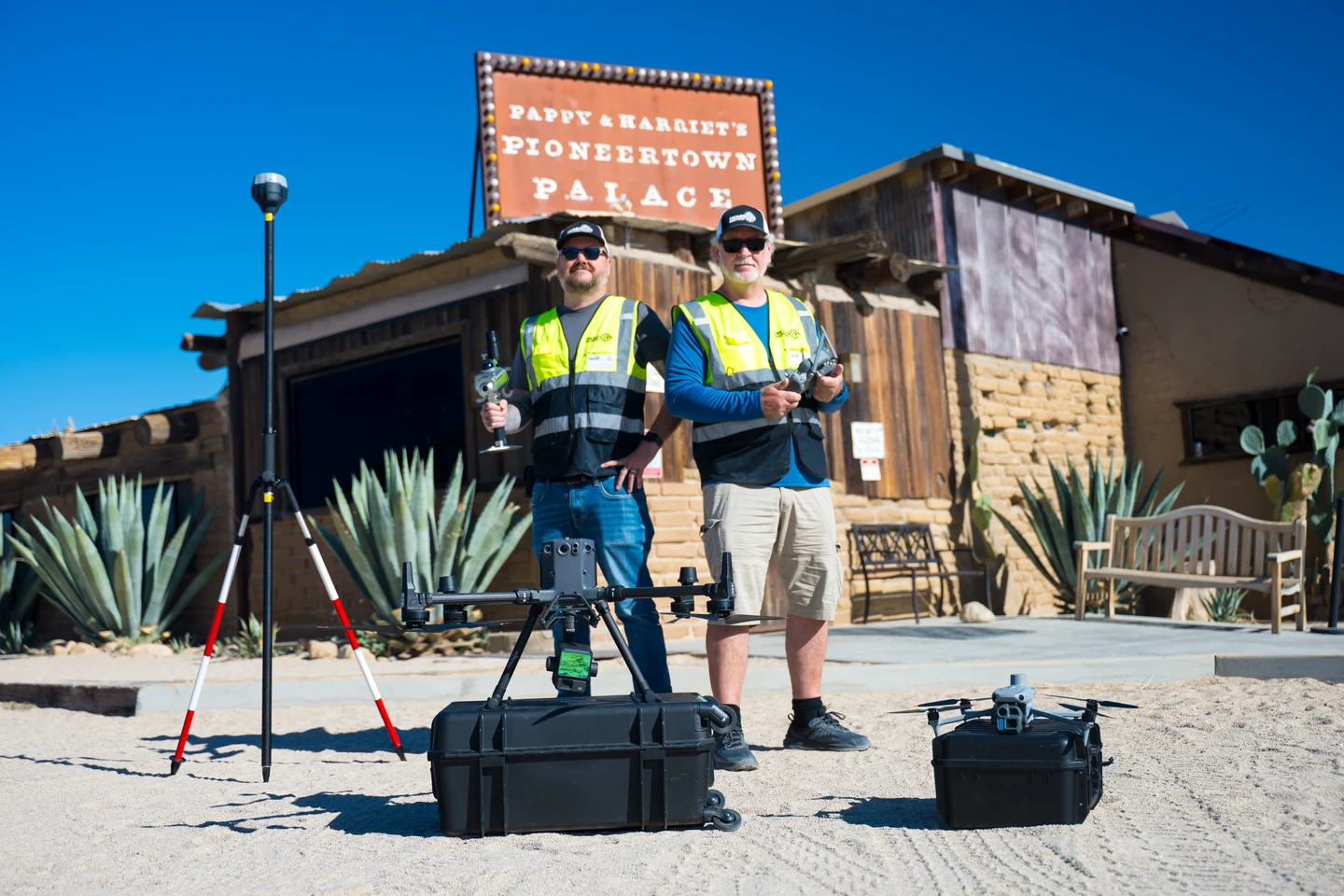 Two Drone Scope Mapping crew members with drones and survey equipment outside Pappy and Harriet’s in Pioneertown.