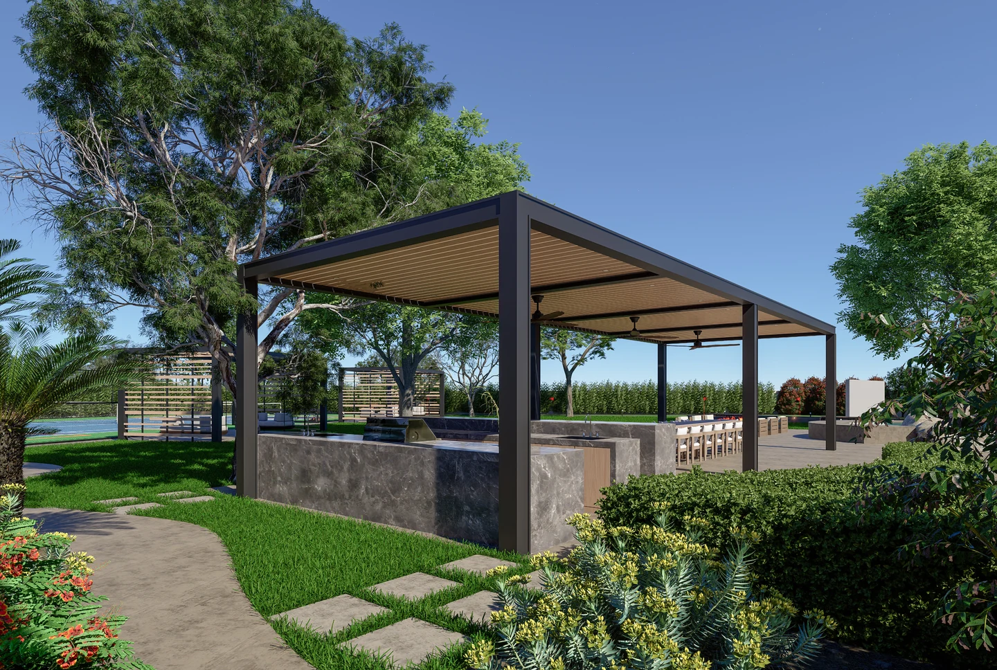 A garden pavilion with a slatted wood ceiling, stone outdoor kitchen, shaded dining, and lush surrounding landscape.